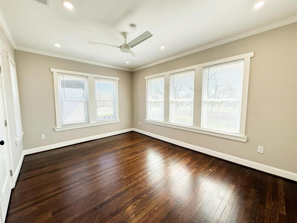 4114 Junius Street, Unit B Dallas, TX 75246 - Photo 16 of 23 a view of an empty room with wooden floor and a window