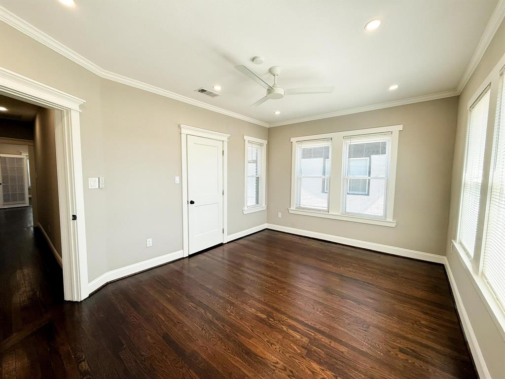4114 Junius Street, Unit B Dallas, TX 75246 - Photo 17 of 23 an empty room with wooden floor and windows