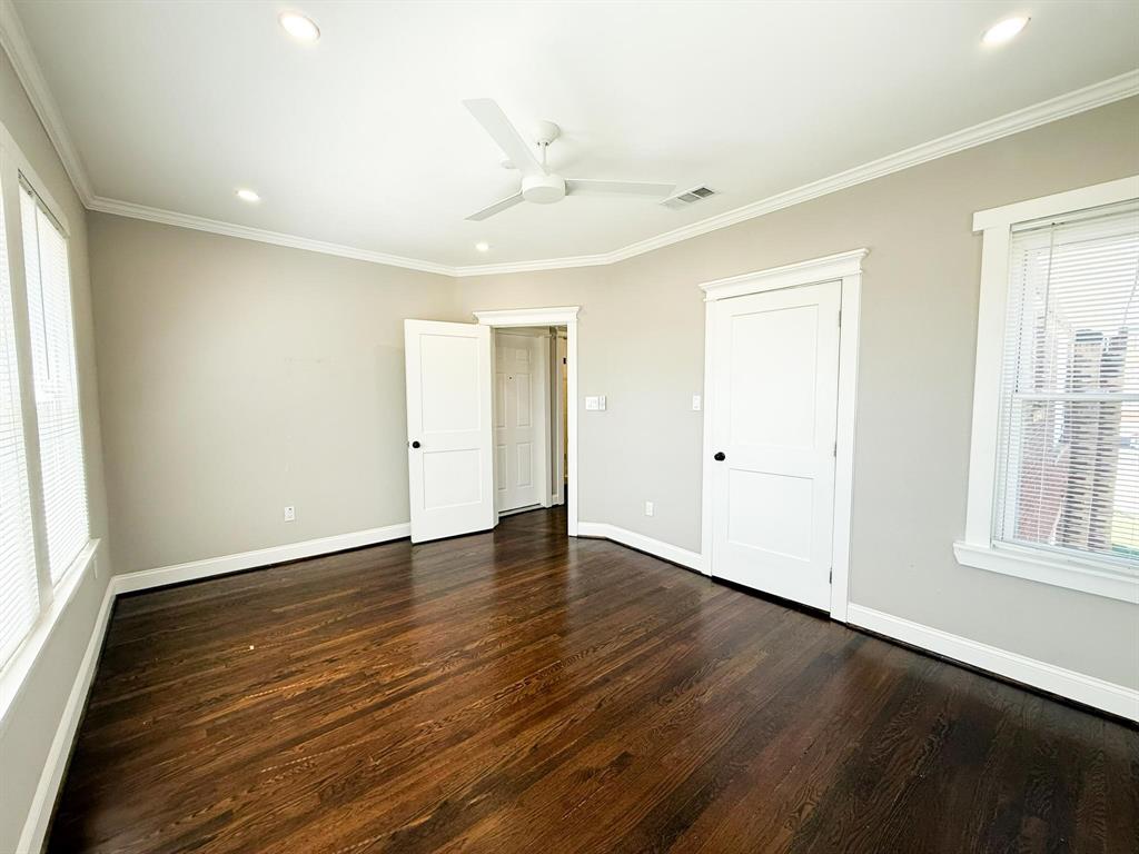 4114 Junius Street, Unit B Dallas, TX 75246 - Photo 18 of 23 an empty room with wooden floor and windows
