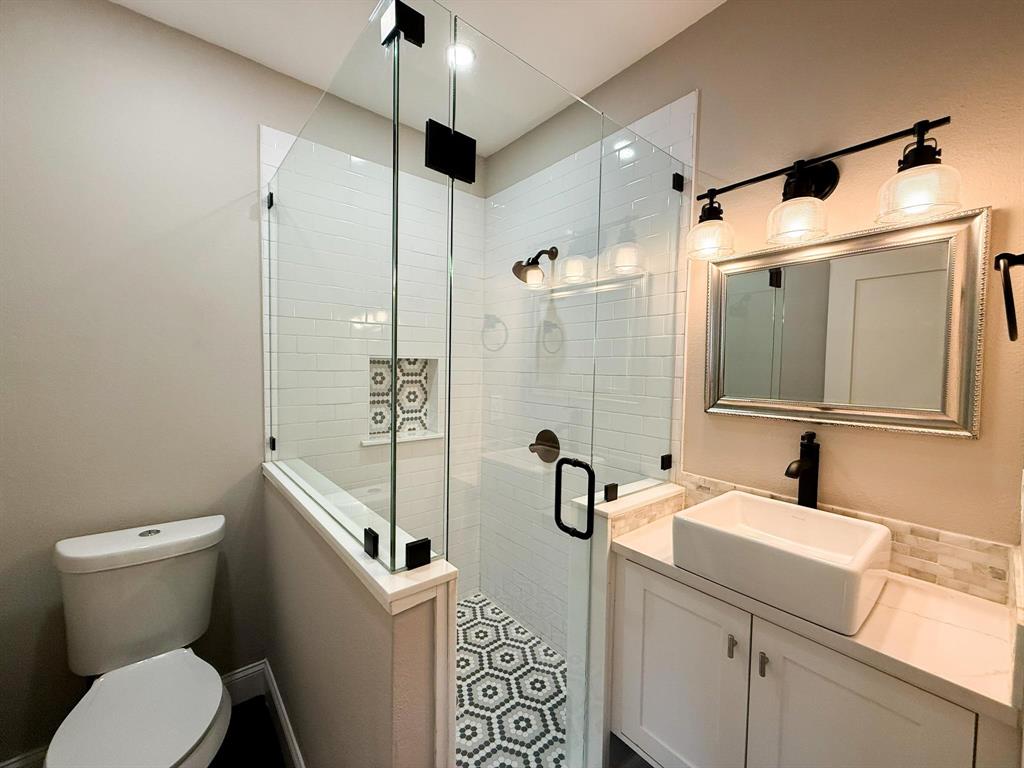 4114 Junius Street, Unit B Dallas, TX 75246 - Photo 21 of 23 a bathroom with a sink a toilet and shower