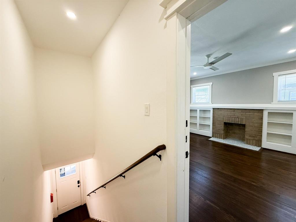 4114 Junius Street, Unit B Dallas, TX 75246 - Photo 5 of 23 a view of a livingroom with wooden floor and a fireplace