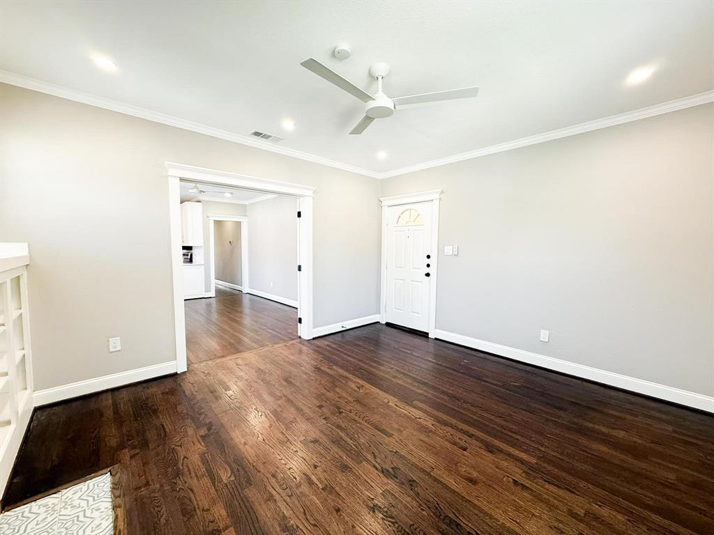 4114 Junius Street, Unit B Dallas, TX 75246 - Photo 7 of 23 an empty room with wooden floor and windows