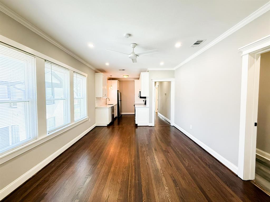 4114 Junius Street, Unit B Dallas, TX 75246 - Photo 8 of 23 a view of an empty room with wooden floor and a window
