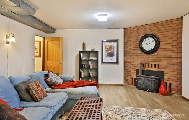 a living room with furniture a clock and a fireplace