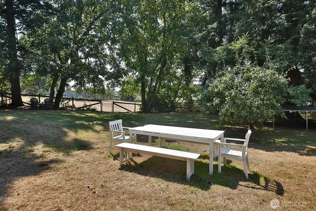 a view of a swimming pool with a patio and a yard