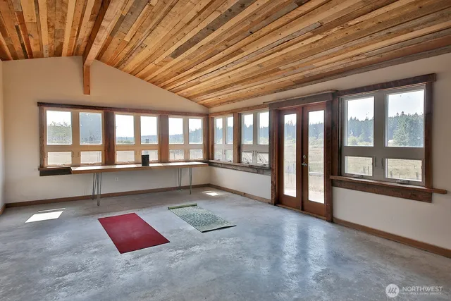 a picture of a room with a white wall and a large window