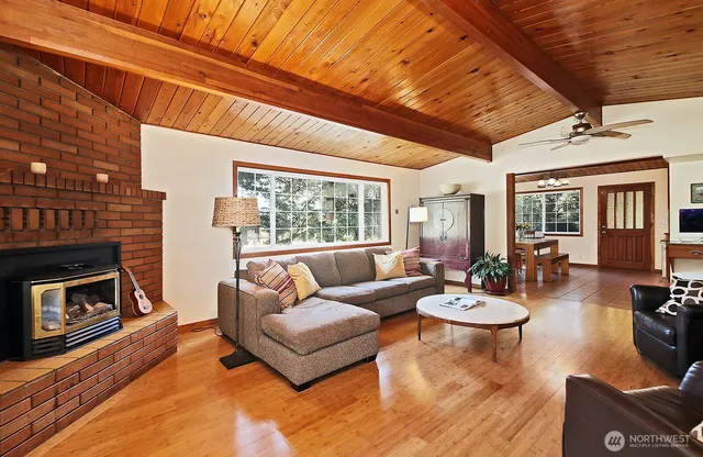 a living room with furniture a fireplace and a table