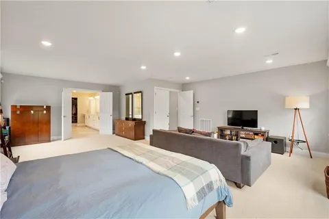 a bedroom with a bed and a television