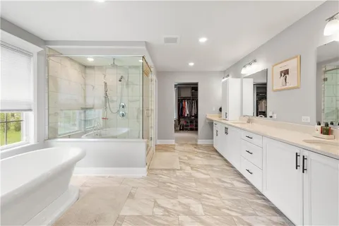 a large spacious bathroom with a large tub shower and sink