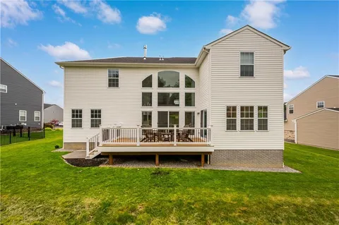 a view of house with backyard and deck