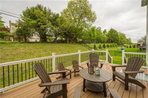 a view of a patio with furniture and a lake