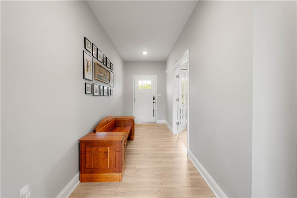 1197 Brook View Court Pittsburgh, PA 15237 - Photo 4 of 30 a hallway with sliding door and wooden floor
