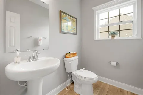 a bathroom with a sink a toilet and a window