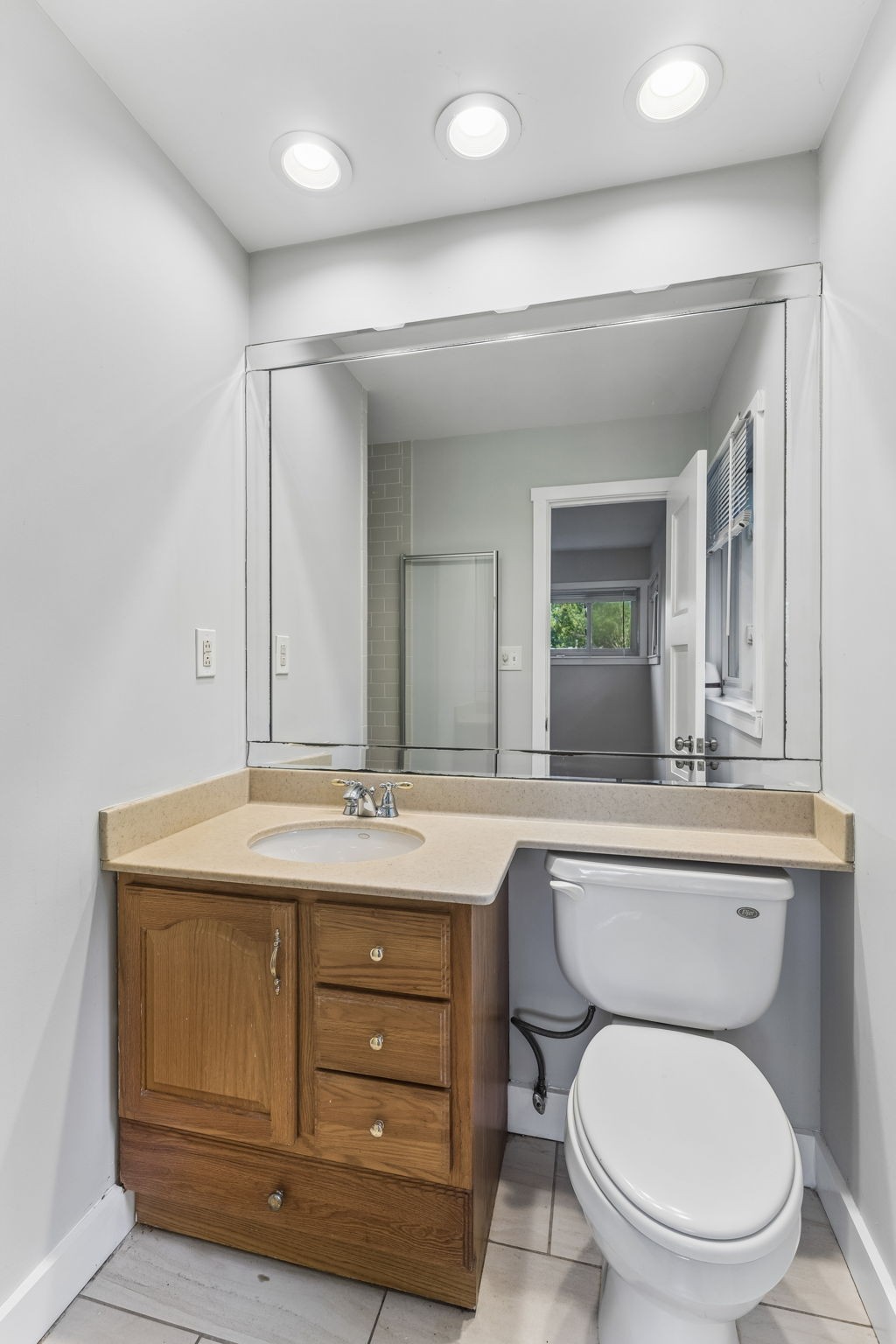 4425 Prescott Road Nashville, TN 37204 - Photo 14 of 36 a bathroom with a granite countertop toilet sink mirror and vanity