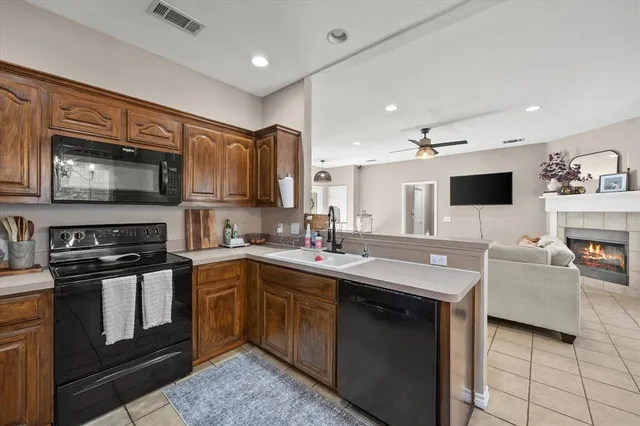 a kitchen with stainless steel appliances a stove sink microwave and cabinets