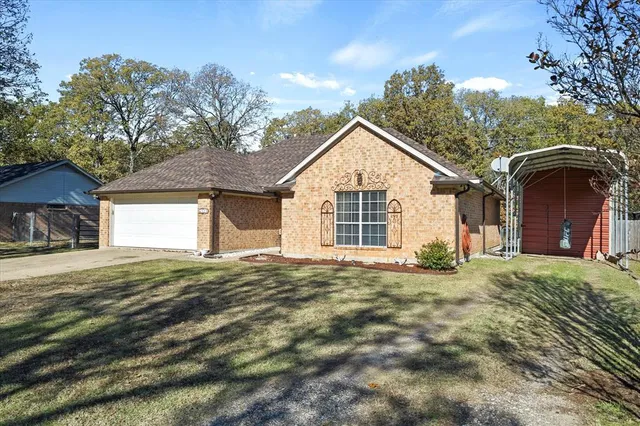 a view of a house with a yard and garage
