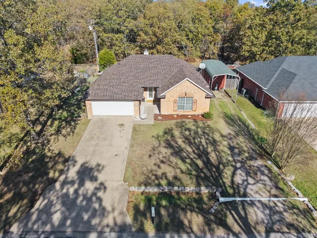 an aerial view of a house with a yard