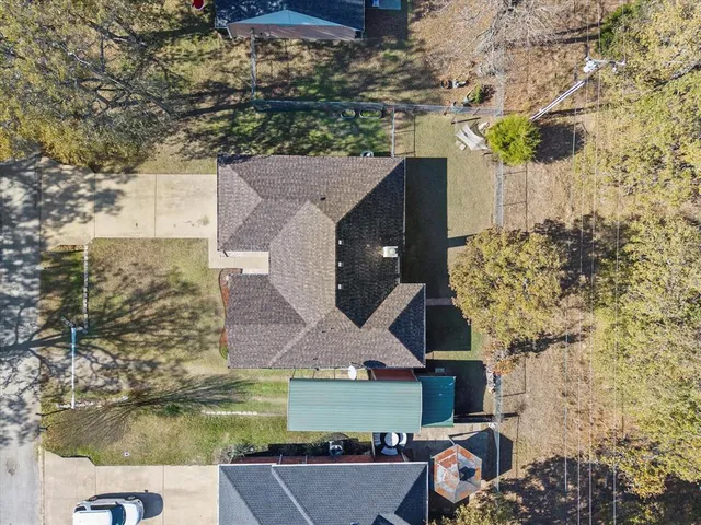 an aerial view of a house with a yard basket ball court and outdoor seating