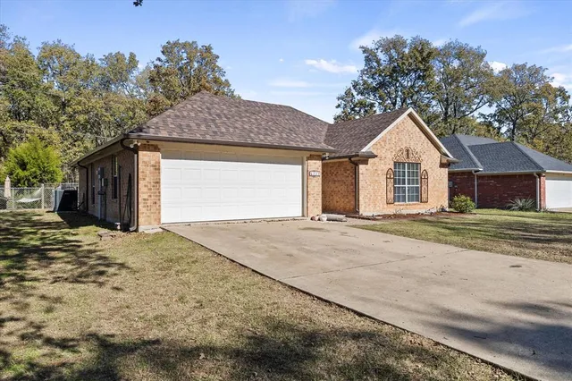 a view of a house with a yard and garage