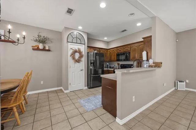 a open kitchen with cabinets and stainless steel appliances