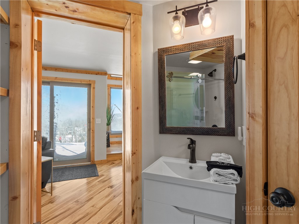 630 Briarcliff Road Sugar Mountain, NC 28604 - Photo 22 of 28 a bathroom with a sink a mirror and a shower