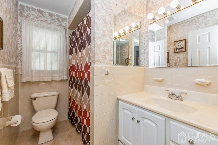 12 New Street Middlesex, NJ 08846 - Photo 13 of 20 a bathroom with a sink a toilet and shower