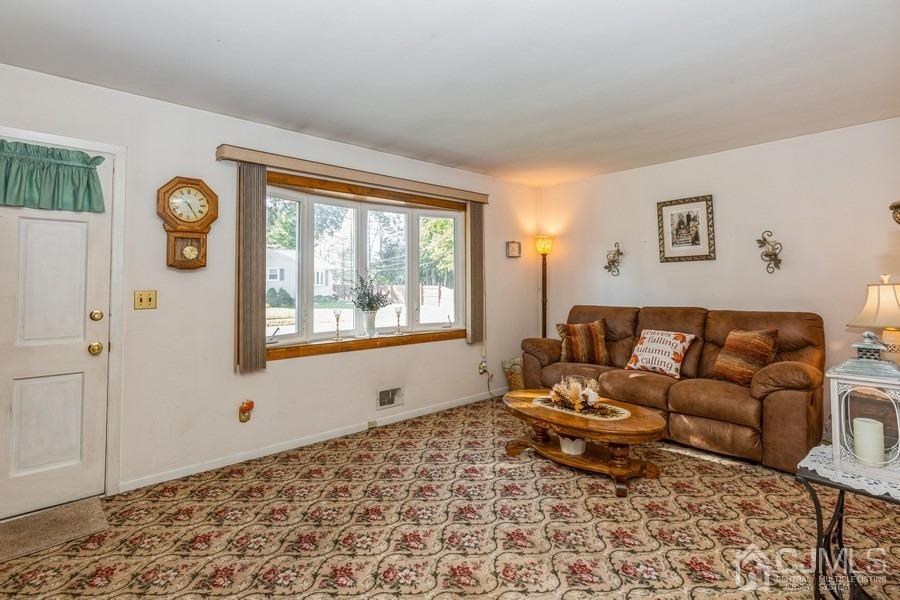 12 New Street Middlesex, NJ 08846 - Photo 4 of 20 a living room with a couch and a window