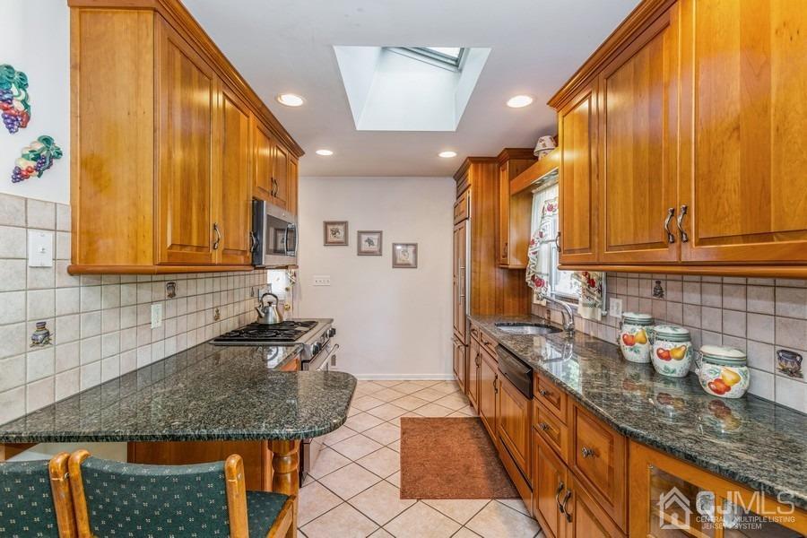 12 New Street Middlesex, NJ 08846 - Photo 8 of 20 a kitchen with granite countertop a sink a stove and cabinets