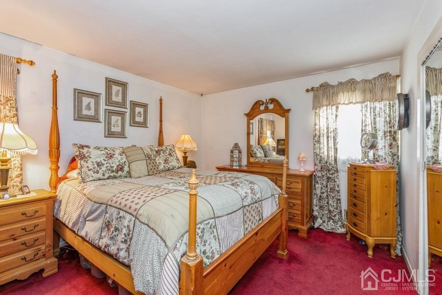 12 New Street Middlesex, NJ 08846 - Photo 10 of 20 a bed sitting in a bedroom next to a window