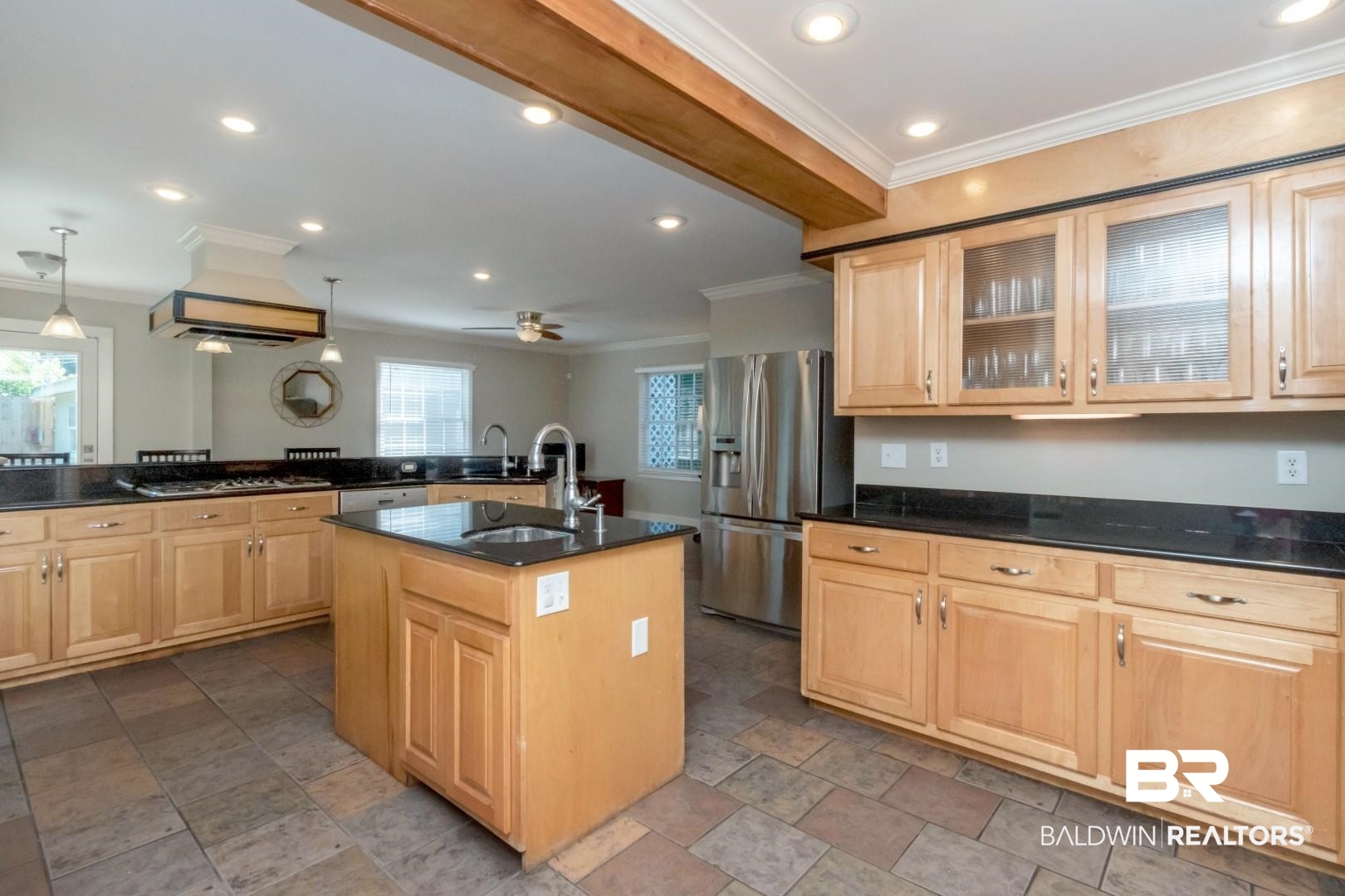 116 Florence Place Mobile, AL 36607 - Photo 11 of 41 Kitchen with light tile patterned flooring, ceiling fan, appliances with stainless steel finishes, light brown cabinetry, and a center island with sink