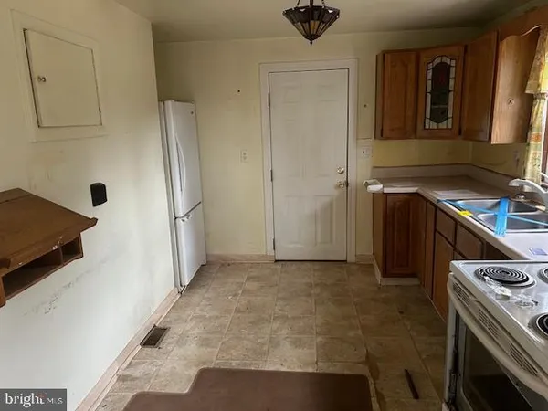 a kitchen with a stove and a refrigerator