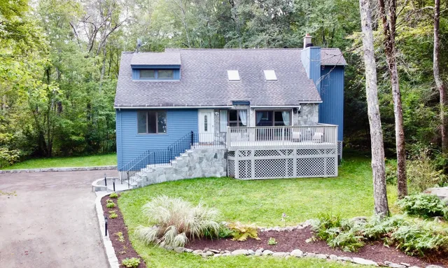 a view of a house with backyard swimming pool and sitting area