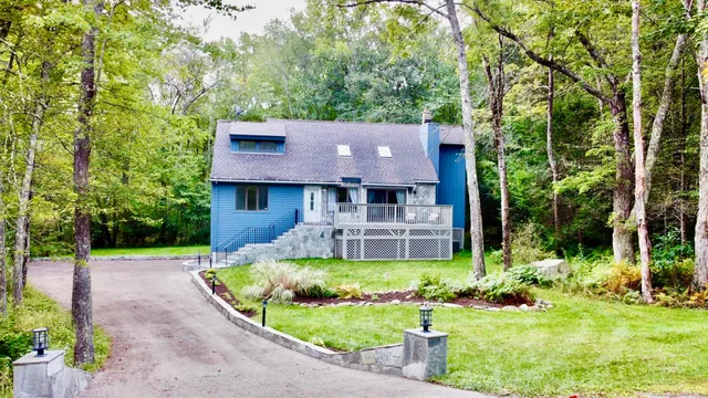 a view of house with swimming pool and garden