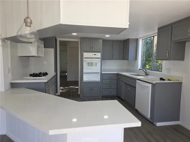 a kitchen with stainless steel appliances a sink stove and refrigerator
