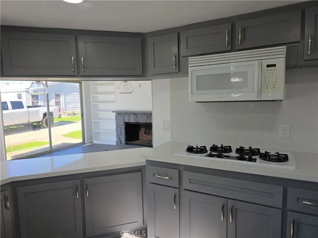 a kitchen with a cabinets and a stove top oven