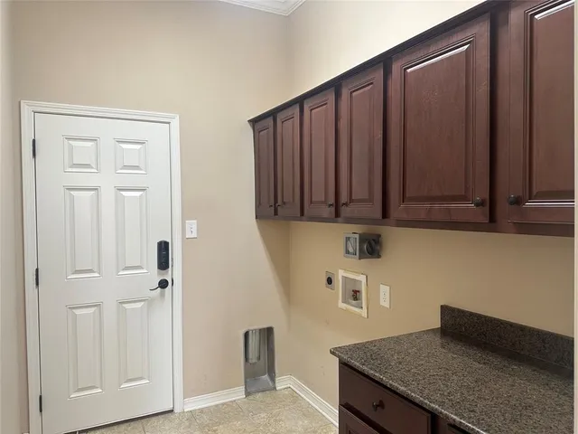 a kitchen with granite countertop cabinets and black appliances