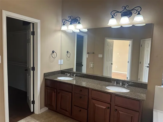a bathroom with a double vanity sink and a mirror