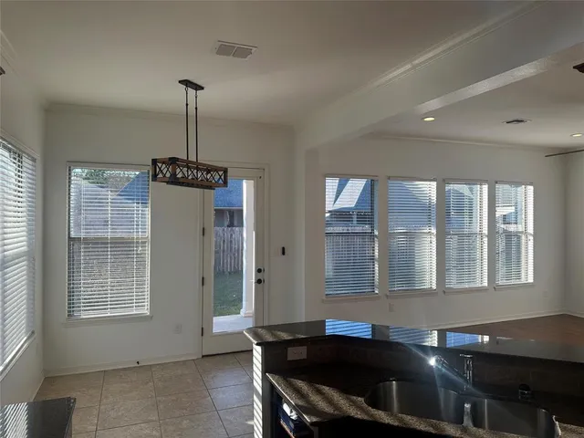 a kitchen with a refrigerator a sink and a window