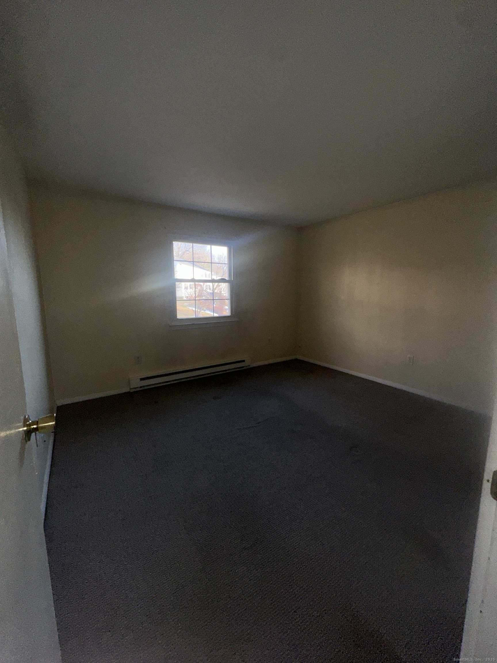 18 Canterbury Arms, Unit 18 New Milford, CT 06776 - Photo 6 of 6 an empty room with a window