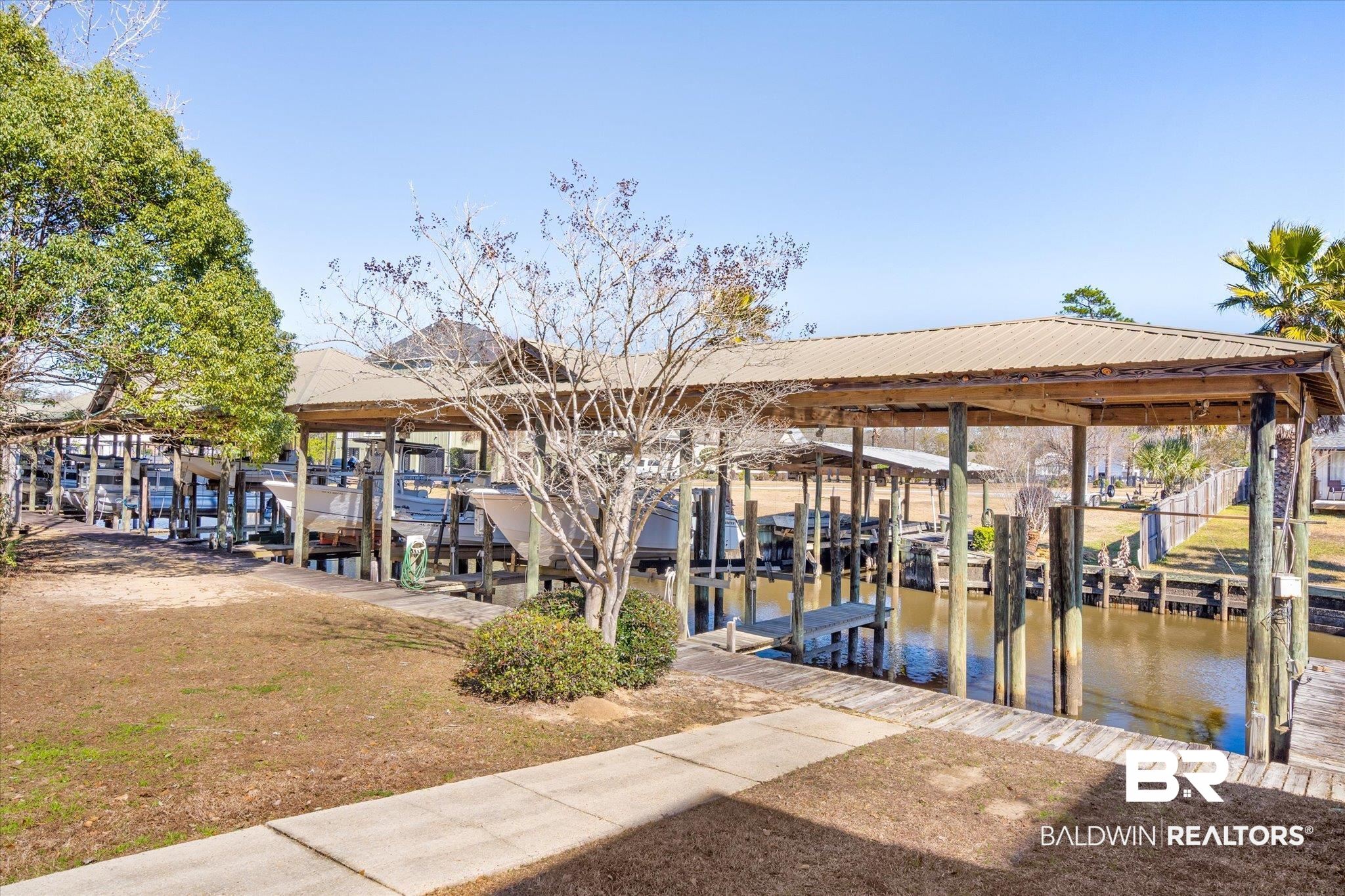 5683 Spring Landing Drive Theodore, AL 36582 - Photo 35 of 49 View of property's community featuring a dock and a water view