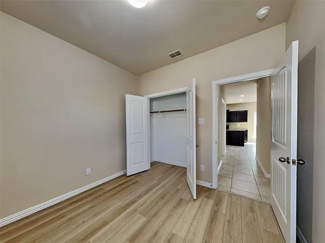 wooden floor in a hall with an empty room
