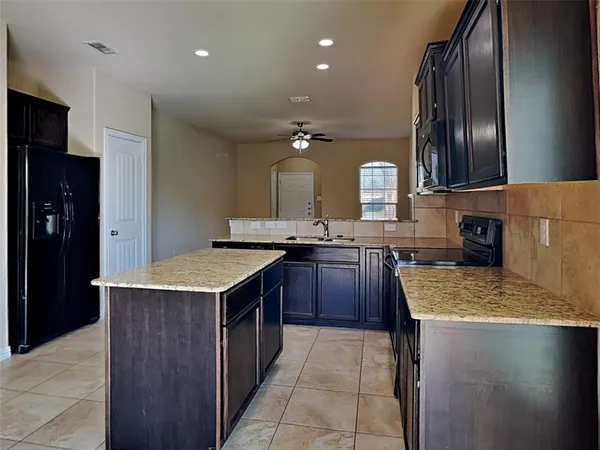 a kitchen with a stove a refrigerator and a sink
