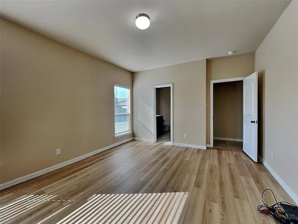 a view of a room with wooden floor and bathroom