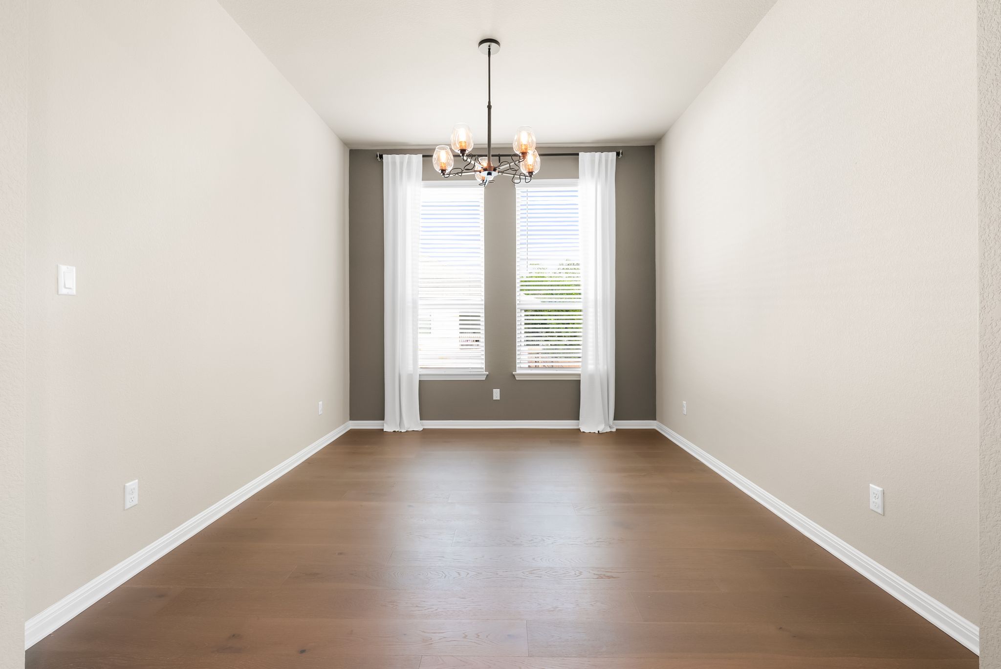 300 Prato Place Georgetown, TX 78628 - Photo 29 of 40 Hardwood floors and an elegant chandelier highlight this versatile dining space.