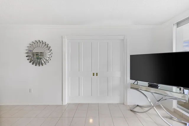 a living room with a flat screen tv and a white wall