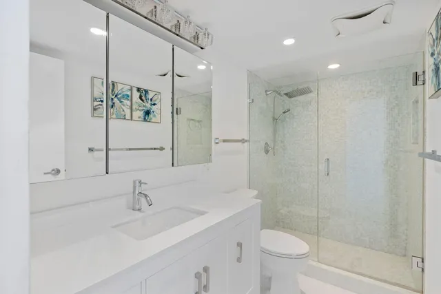 a bathroom with a sink toilet and shower