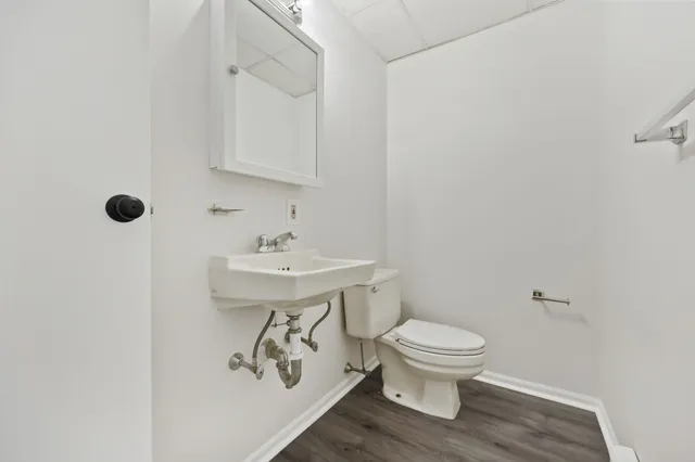 a bathroom with a sink toilet and a mirror