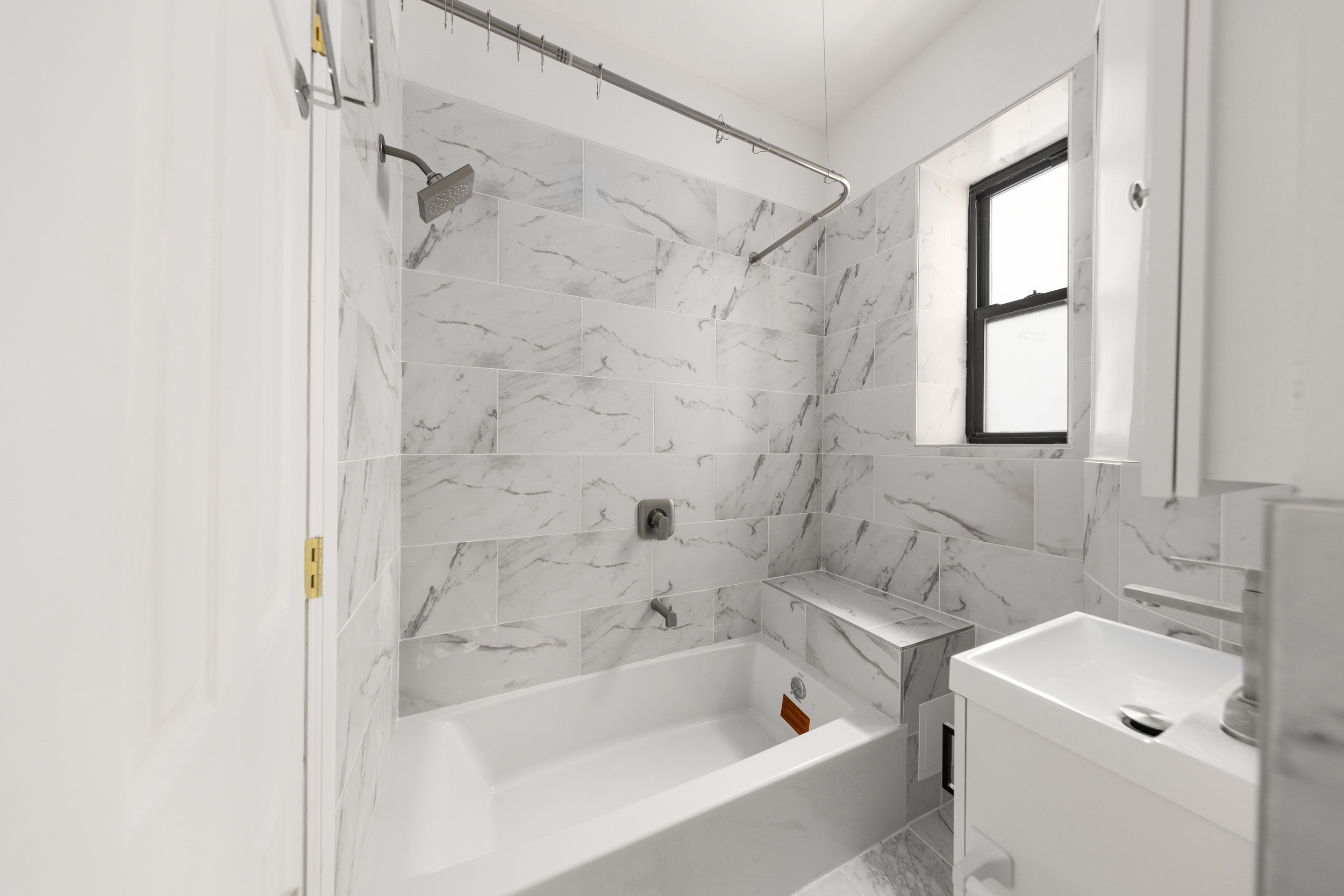552 West 141st Street, Unit 1A Manhattan, NY 10031 - Photo 3 of 6 a bathroom with a bathtub shower sink vanity and toilet