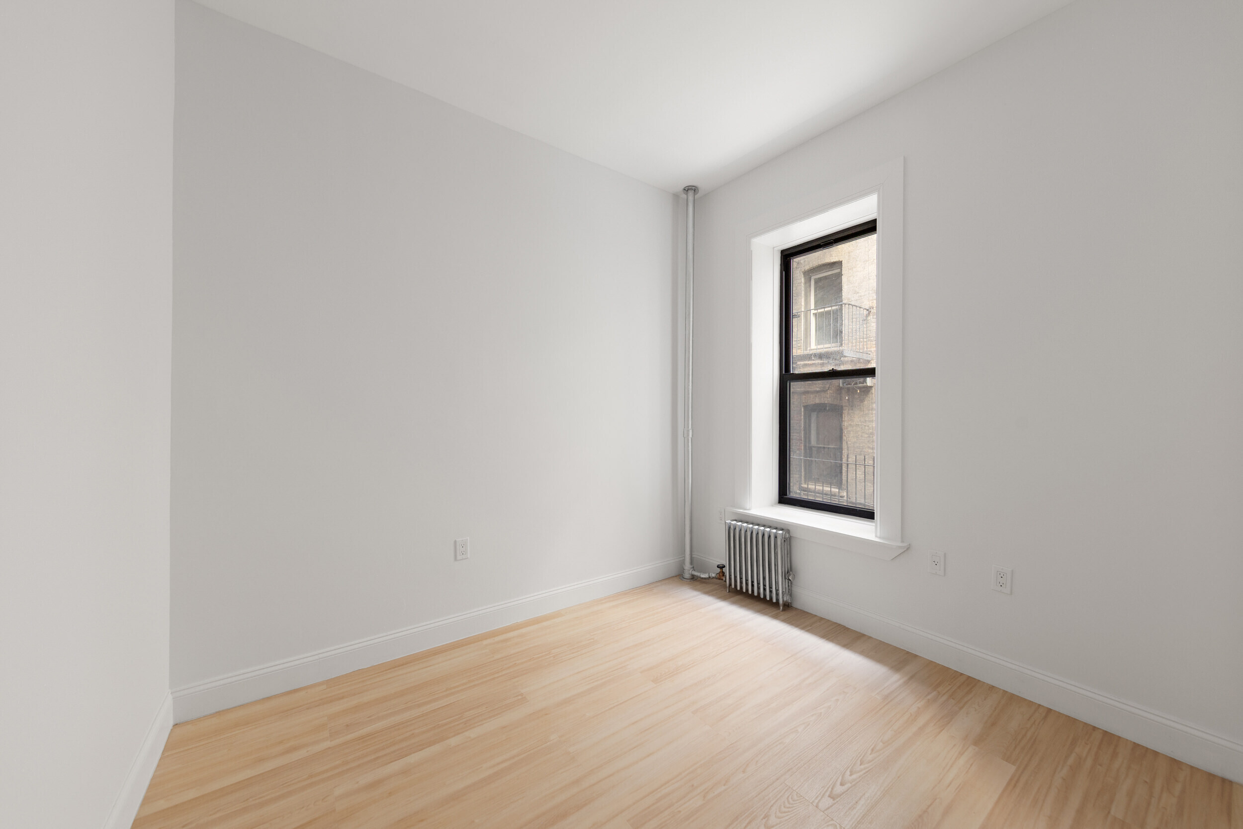 552 West 141st Street, Unit 1A Manhattan, NY 10031 - Photo 5 of 6 a view of an empty room with a window