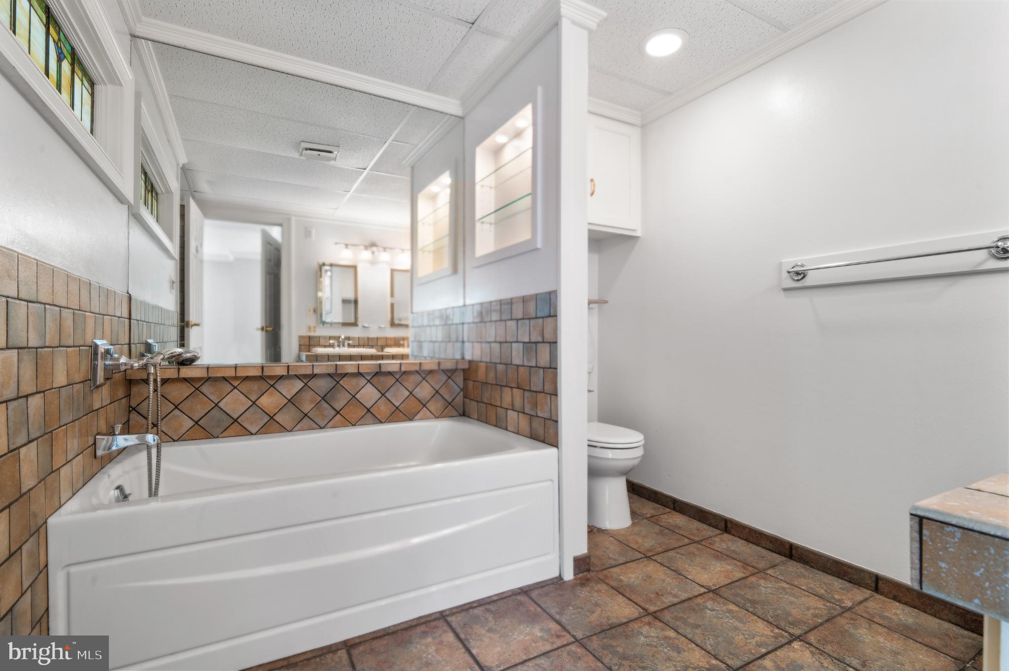 15729 Holly Grove Road Silver Spring, MD 20905 - Photo 54 of 83 a bathroom with a bathtub and a shower